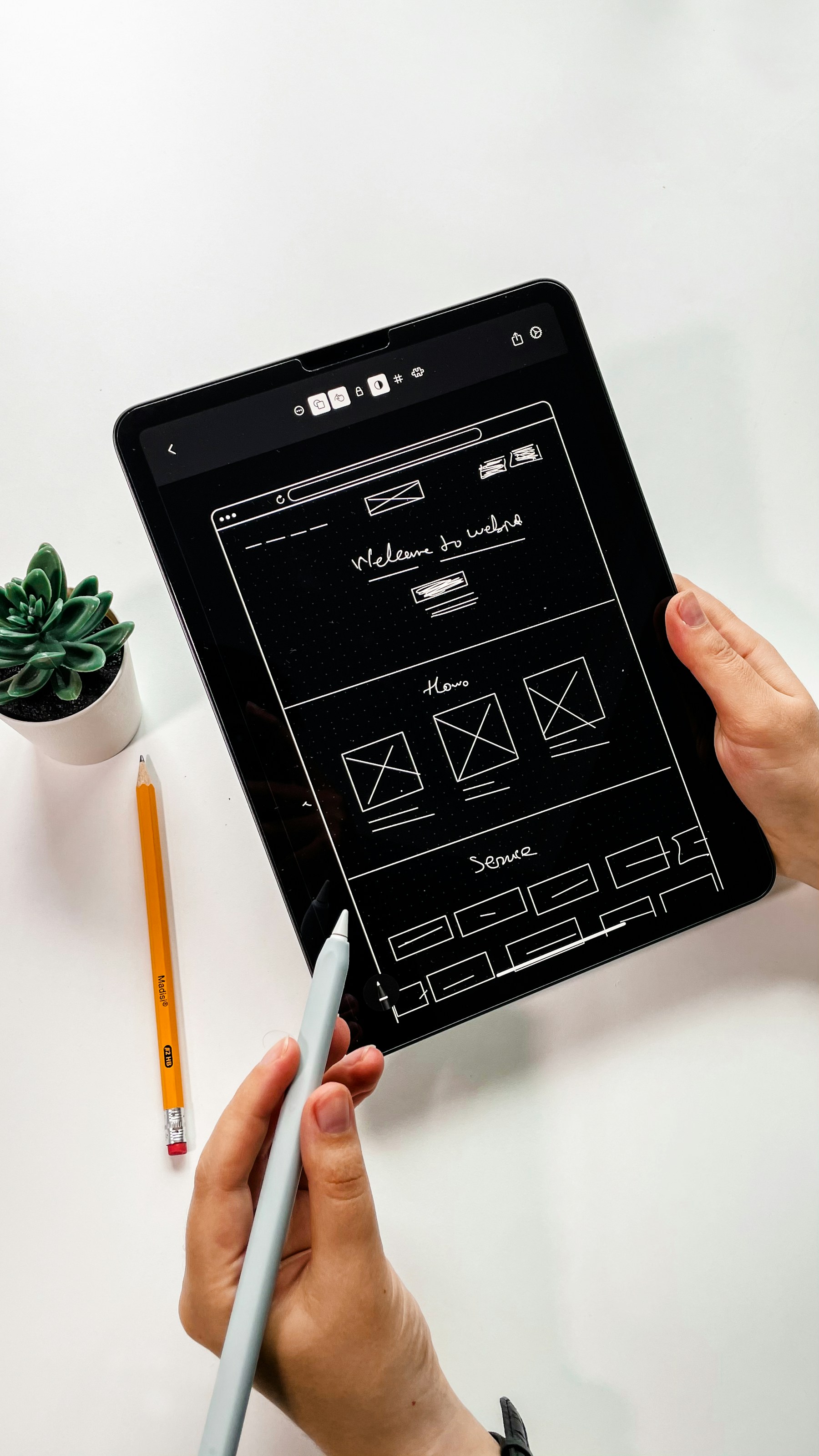 A tablet showing a website wireframe